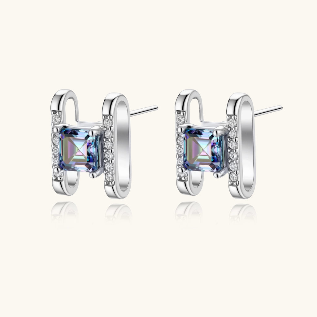 Square moissanite studs in sterling silver geometric setting showing rainbow prismatic fire on white background.