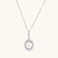 Oval sterling silver pendant with crystal halo surrounding a white freshwater pearl on delicate chain